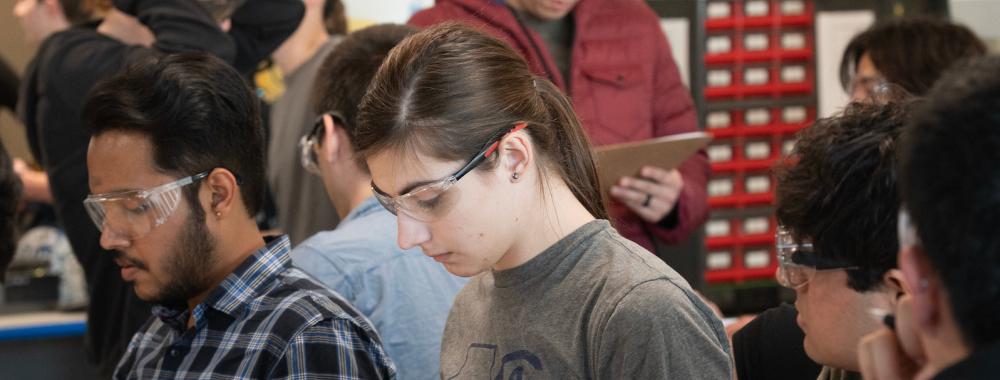 Students do work in an engineering setting.